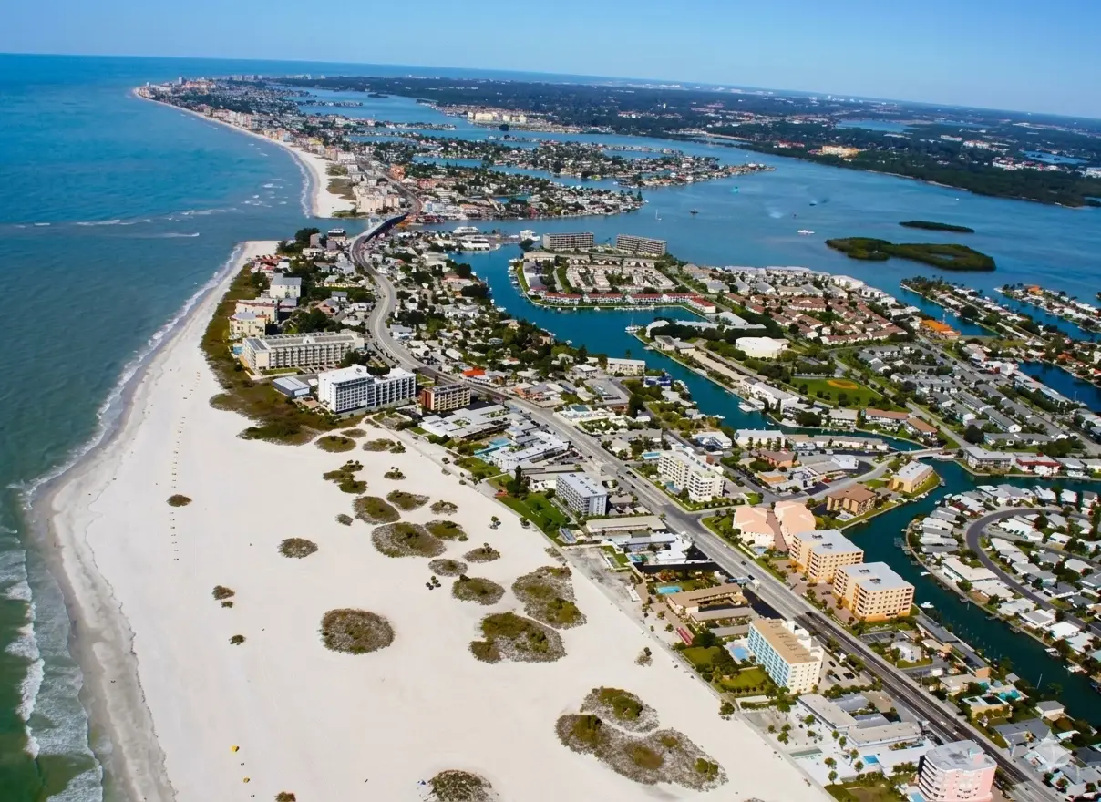 An expansive aerial view of a white sand coastline dotted with luxury resorts perfect for custom tile installation Treasure Island.